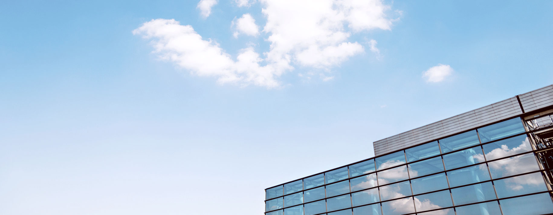 Clouds reflected on glass office building